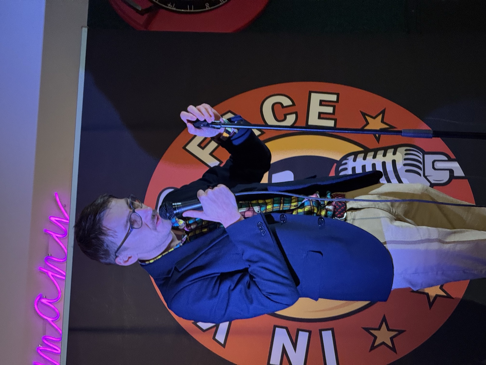 Woocash performing stand-up at IN YOUR FACE Comedy in Zürich
