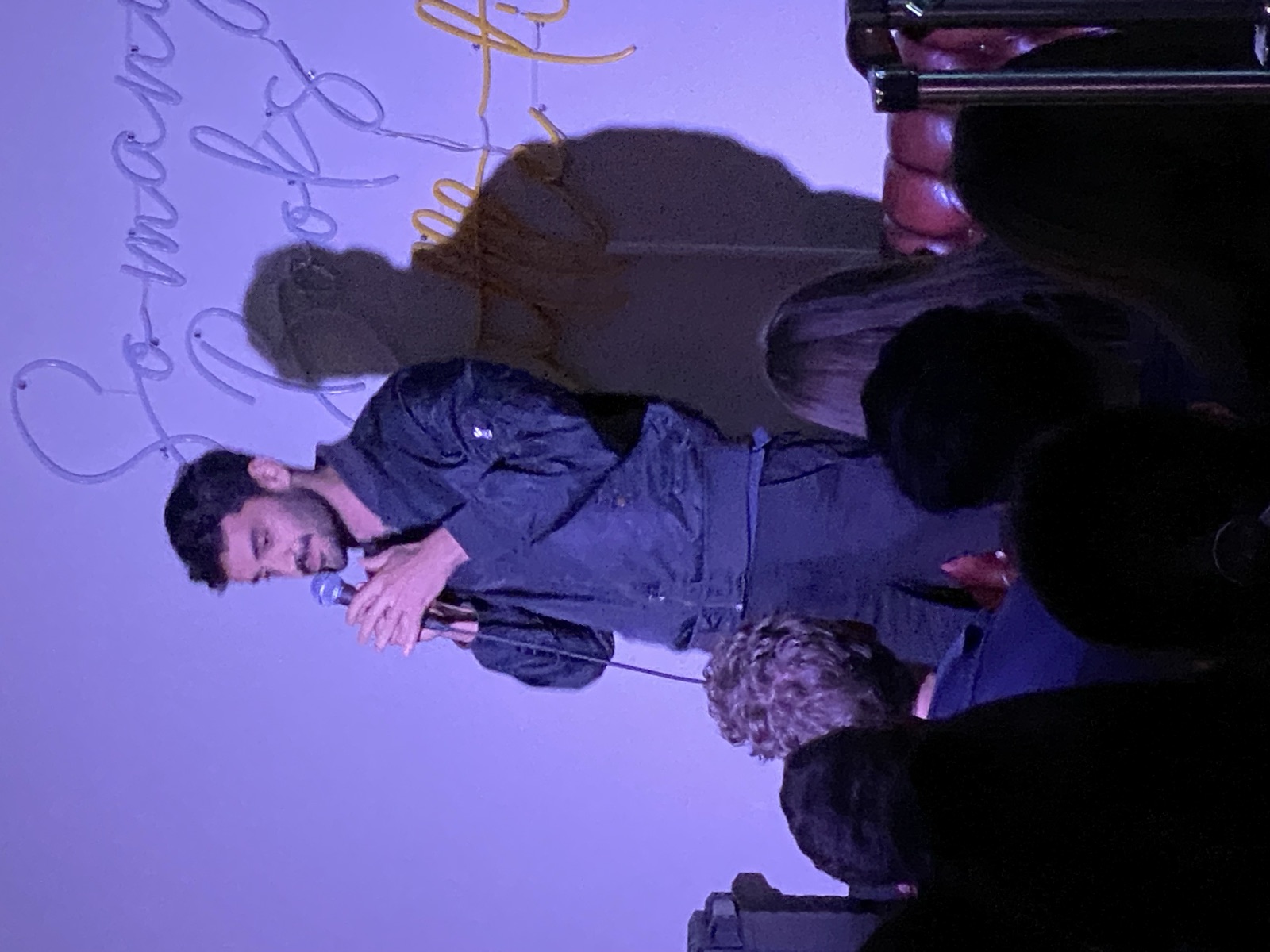 Pouya performing stand-up at IN YOUR FACE Comedy in Zürich