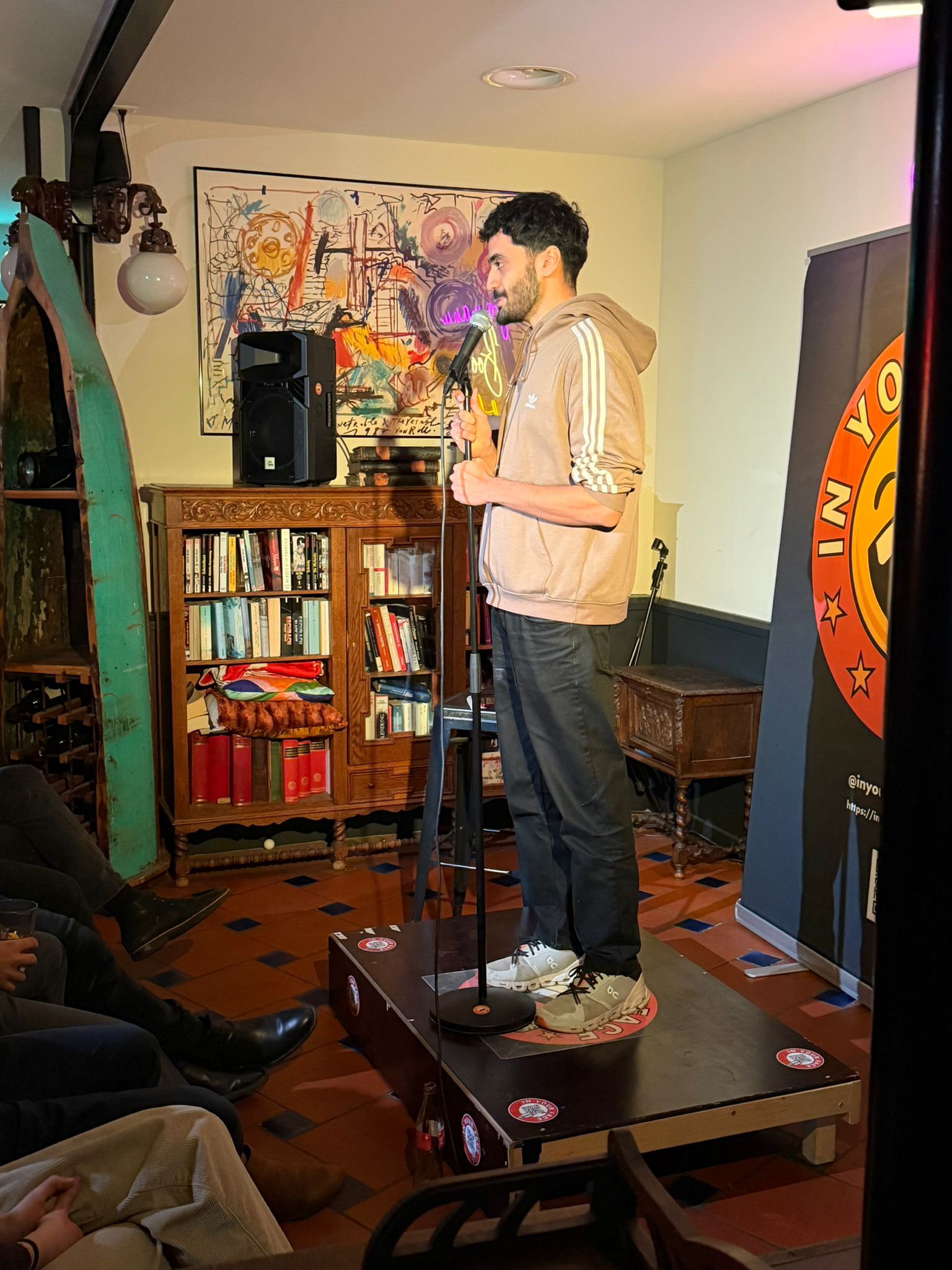 Pouya performing stand-up at IN YOUR FACE Comedy in Zürich